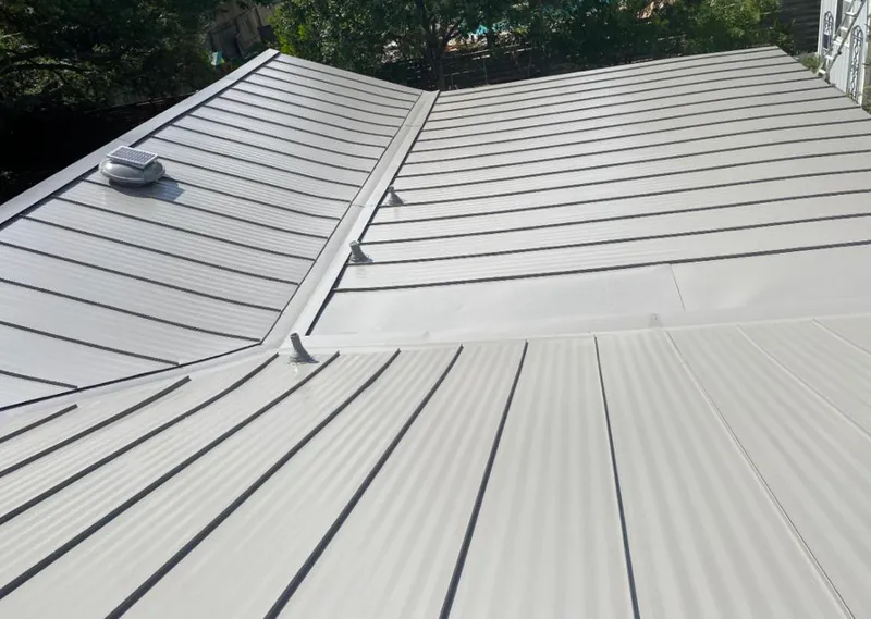 Solar attic fan installed on a metal roof for Roof Ventilation in Palm Valley
